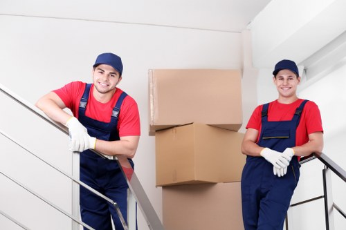 Moving team using safe lifting practices during a van loading operation