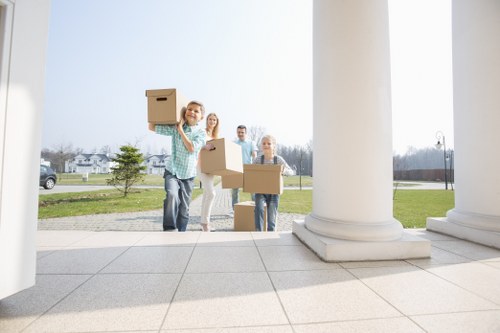 Packed boxes and furniture prepared for transport by movers in Harrow