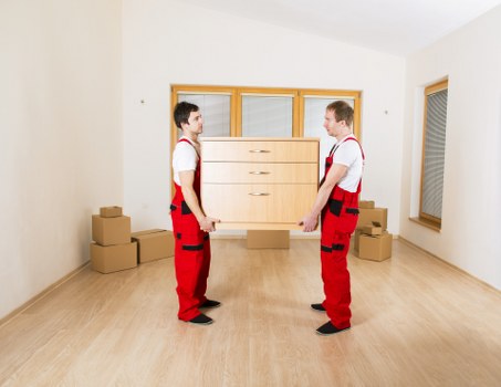 Removalists carefully loading household items for a Harrow move
